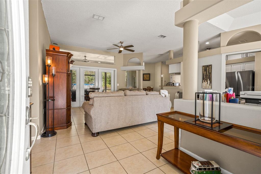 11128 Lomita Wren Road Weeki Wachee, FL 34614 - Photo 7 of 39 a living room with furniture and a flat screen tv