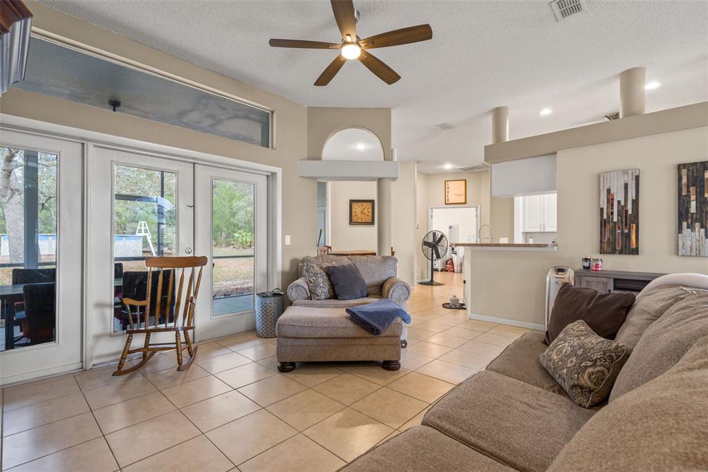 11128 Lomita Wren Road Weeki Wachee, FL 34614 - Photo 8 of 39 a living room with furniture and a large window