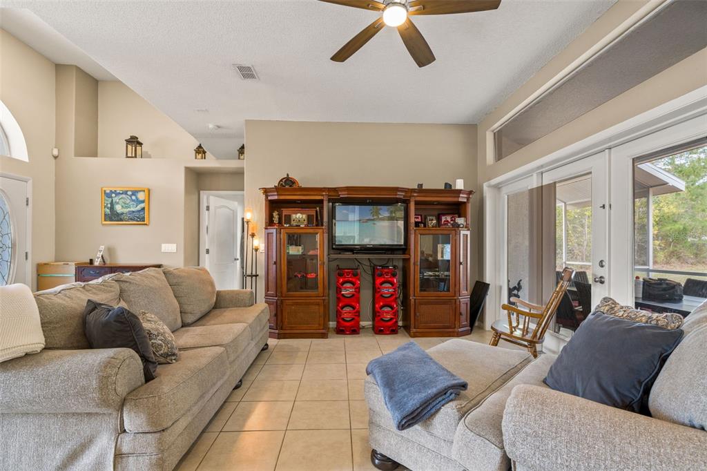11128 Lomita Wren Road Weeki Wachee, FL 34614 - Photo 9 of 39 a living room with furniture and a flat screen tv
