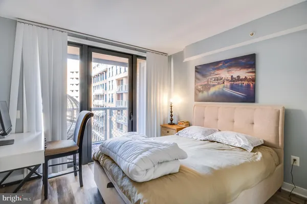 a bedroom with a bed and a large window
