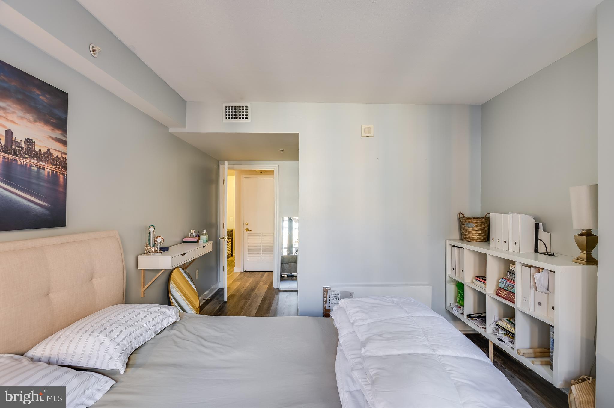 631 D Street Northwest, Unit 837 Washington, DC 20004 - Photo 18 of 29 a bedroom with a bed and a book shelf