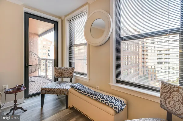 a living room with furniture and a floor to ceiling window