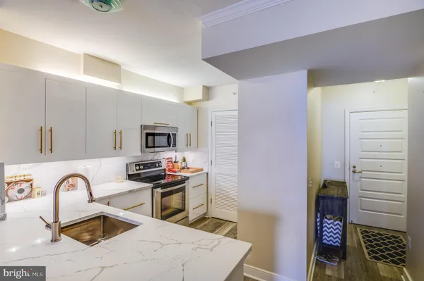 a kitchen with stainless steel appliances granite countertop a sink and a stove top oven
