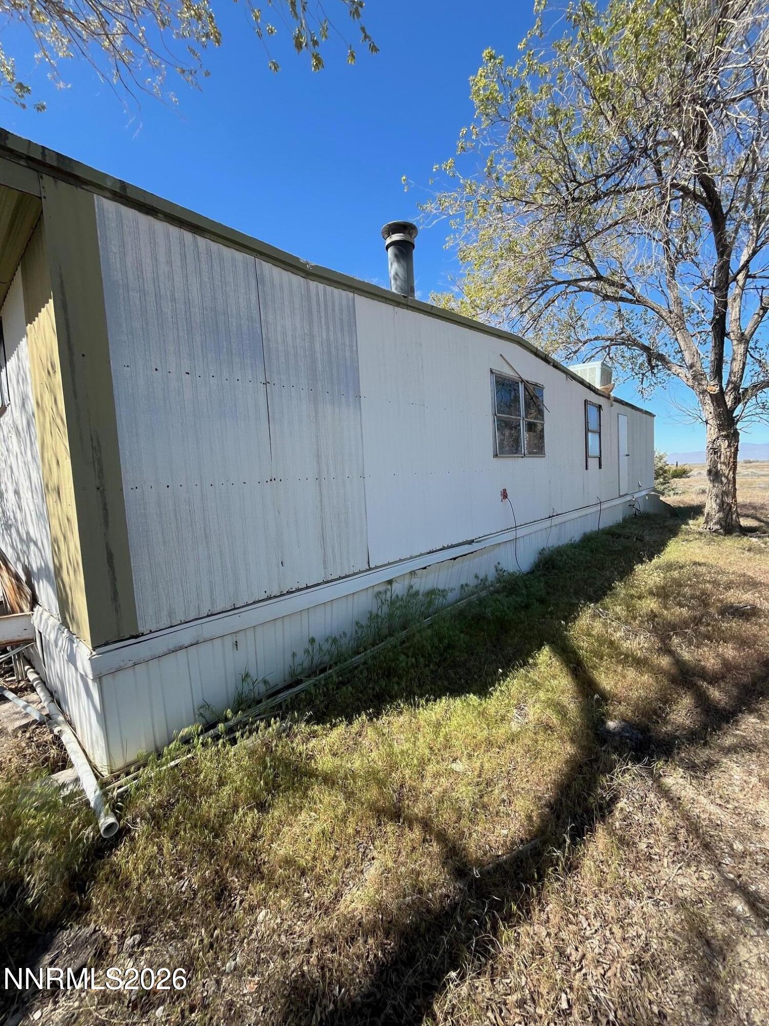 100 Prince Royal Road Imlay, NV 89418 - Photo 11 of 12 a backyard of a house with a large tree