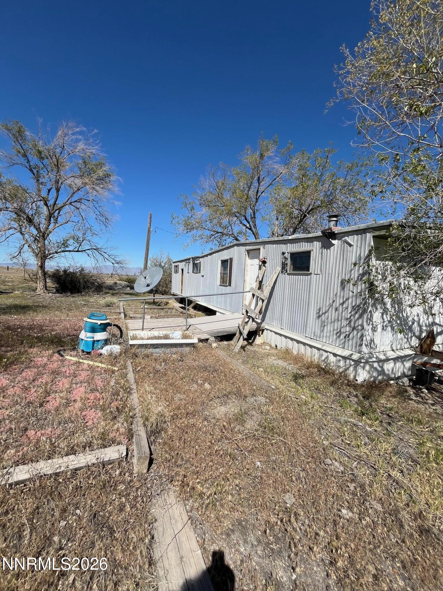 100 Prince Royal Road Imlay, NV 89418 - Photo 6 of 12 a view of a dirt road with large trees