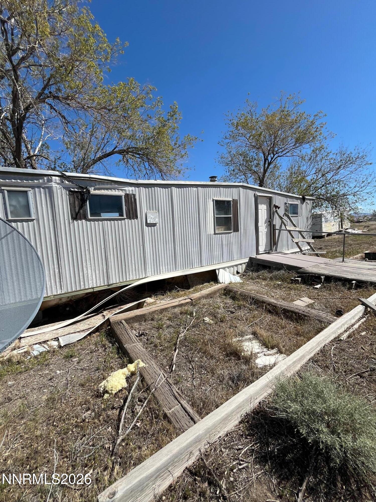 100 Prince Royal Road Imlay, NV 89418 - Photo 7 of 12 a view of a house with a wooden fence