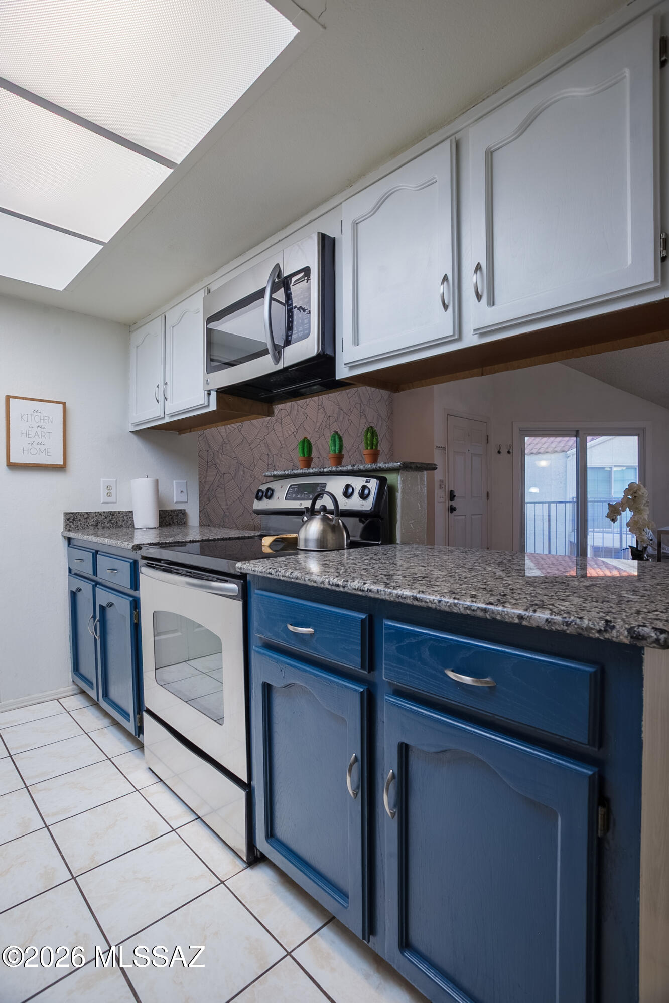1200 East River Road, Unit B27 Tucson, AZ 85718 - Photo 17 of 40 a kitchen with stainless steel appliances granite countertop a sink and a stove