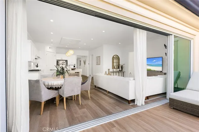 a kitchen with a dining table chairs cabinets and stainless steel appliances