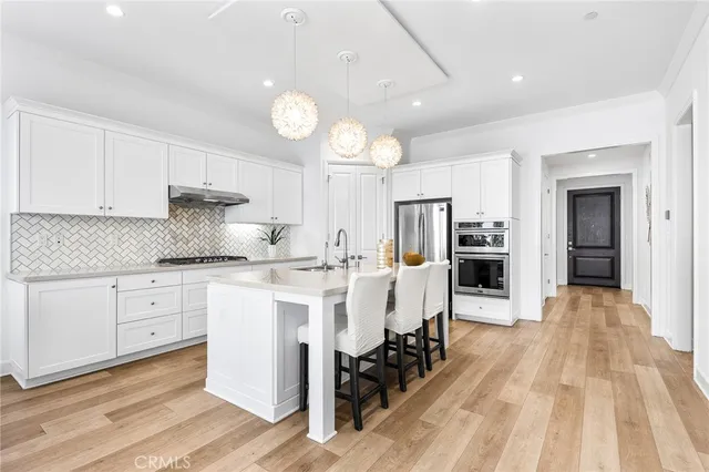 a kitchen with white cabinets and a stove