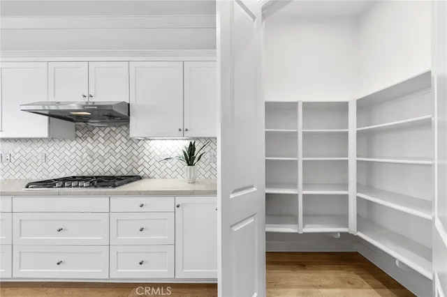 a spacious bathroom with a granite countertop tub a sink and a large mirror