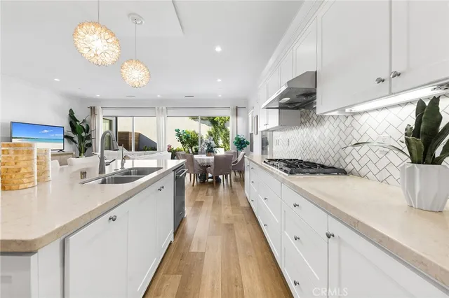 a bathroom with a double vanity sink mirror and next to a window
