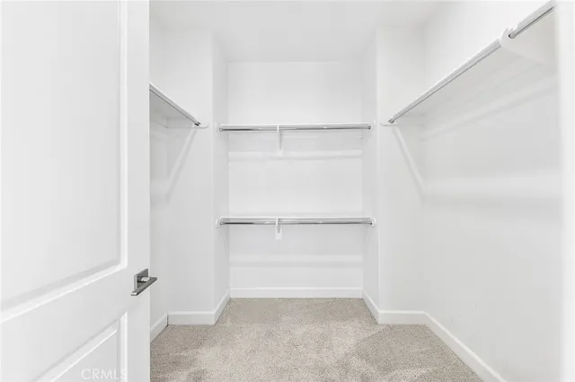 a view of a hallway with wooden floor and entryway