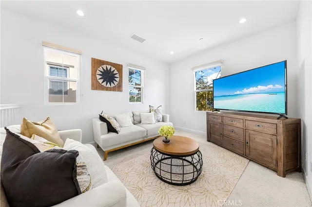 a bathroom with a bathtub shower sink vanity mirror and toilet