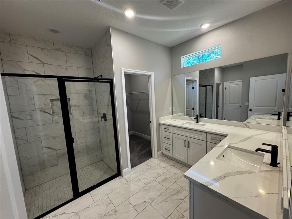 13101 Southwest 72nd Terrace Road Ocala, FL 34473 - Photo 9 of 18 a spacious bathroom with a shower sink and mirror
