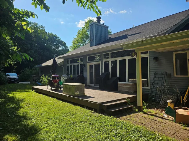 a view of a house with a backyard porch and sitting area