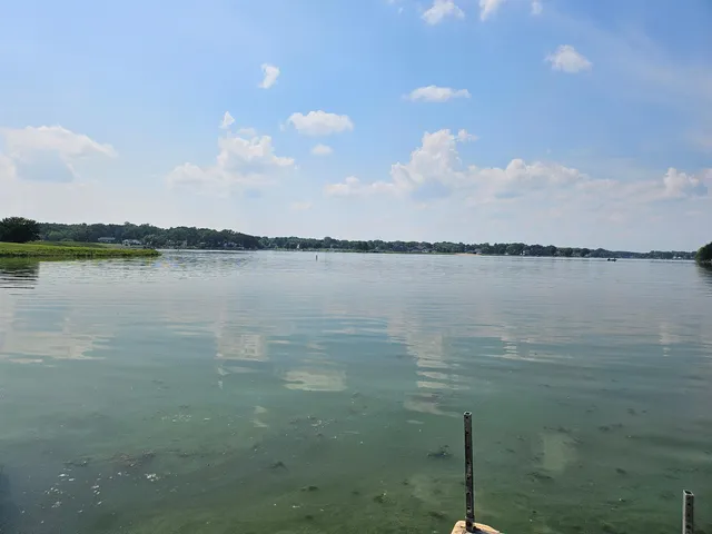 a view of a lake with couches chairs