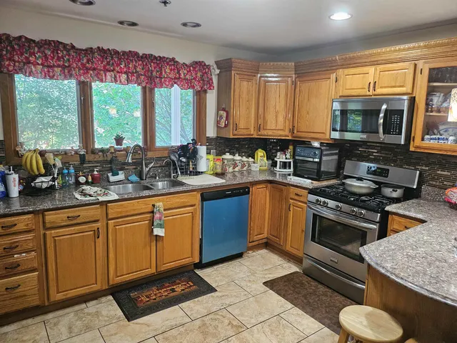 a bed sitting in a bedroom next to a cabinet