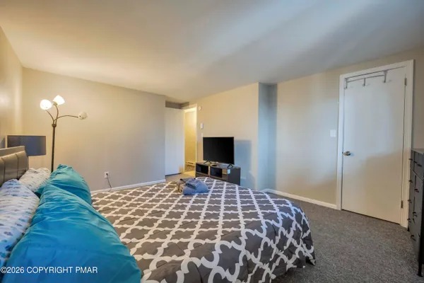 a bedroom with a bed and a flat screen tv