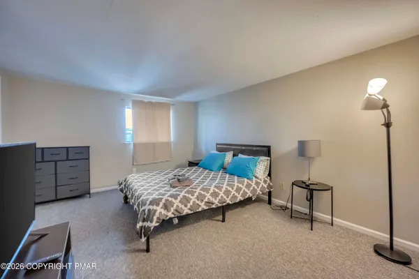 a bedroom with a bed and a night stand