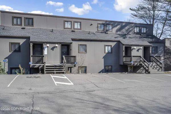 a view of a building with car parked