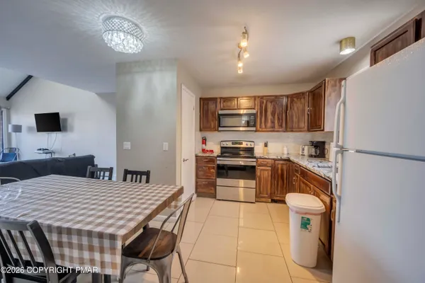 a kitchen with a refrigerator a stove top oven a sink dishwasher and cabinets
