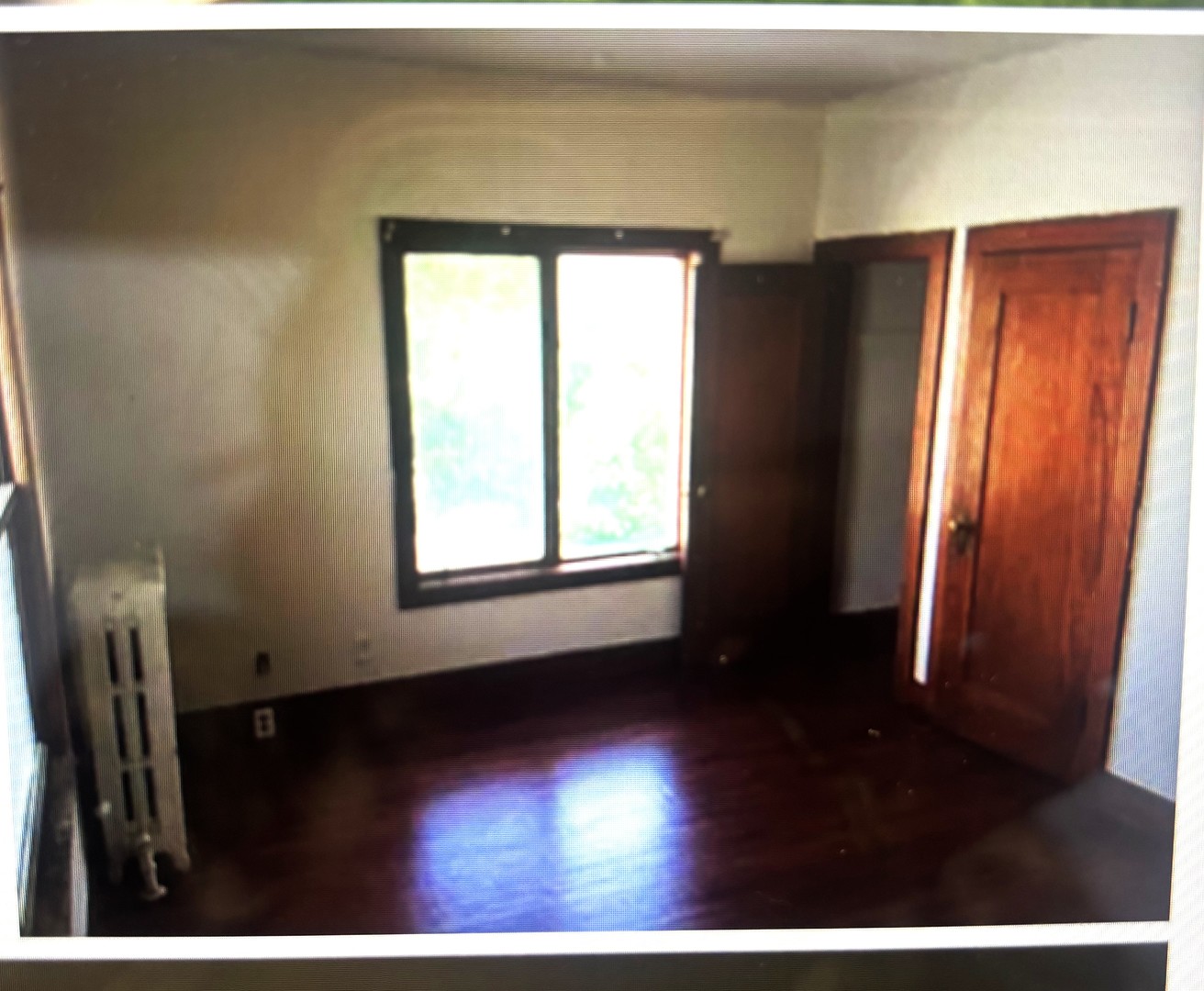 217 South 3rd Street DeKalb, IL 60115 - Photo 14 of 20 a view of an empty room with wooden floor and a window
