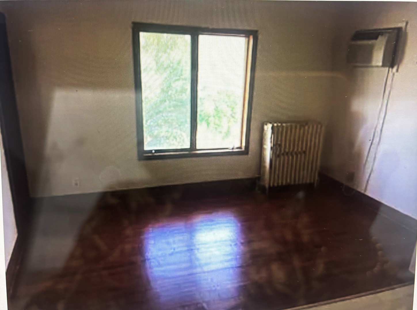 217 South 3rd Street DeKalb, IL 60115 - Photo 15 of 20 a view of an empty room with wooden floor and a window