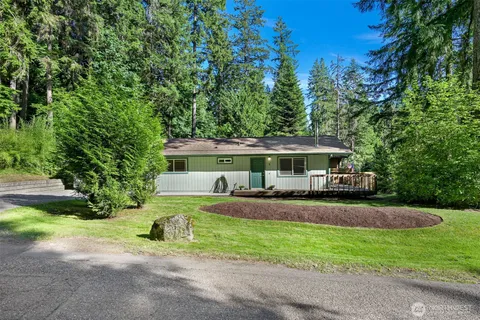 a view of a house with a yard and sitting area