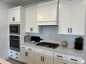 12 South Moonlit Road Mapleton, UT 84664 - Photo 3 of 14 Kitchen featuring custom exhaust hood, white cabinetry, stainless steel oven, and built in microwave