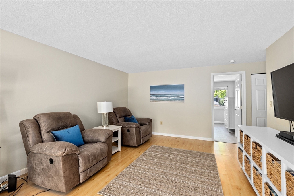 4 Beal's Cove Road, Unit B Hingham, MA 02043 - Photo 7 of 16 a living room with furniture and a flat screen tv