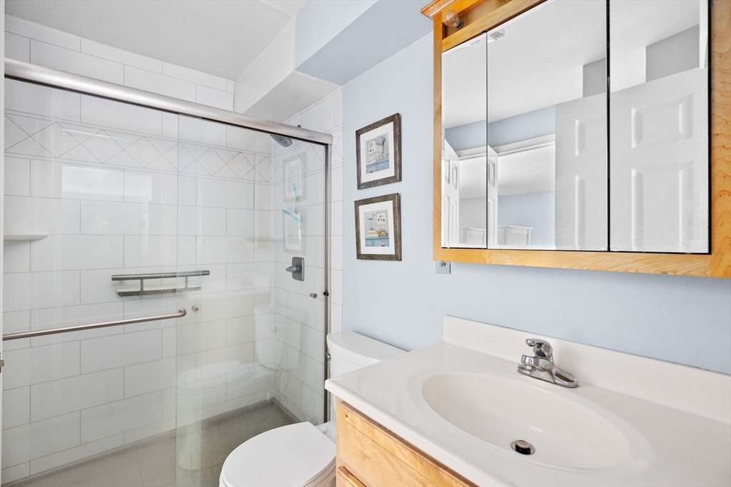 4 Beal's Cove Road, Unit B Hingham, MA 02043 - Photo 9 of 16 a bathroom with a sink toilet and shower