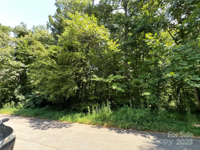 a view of a wooden fence and trees
