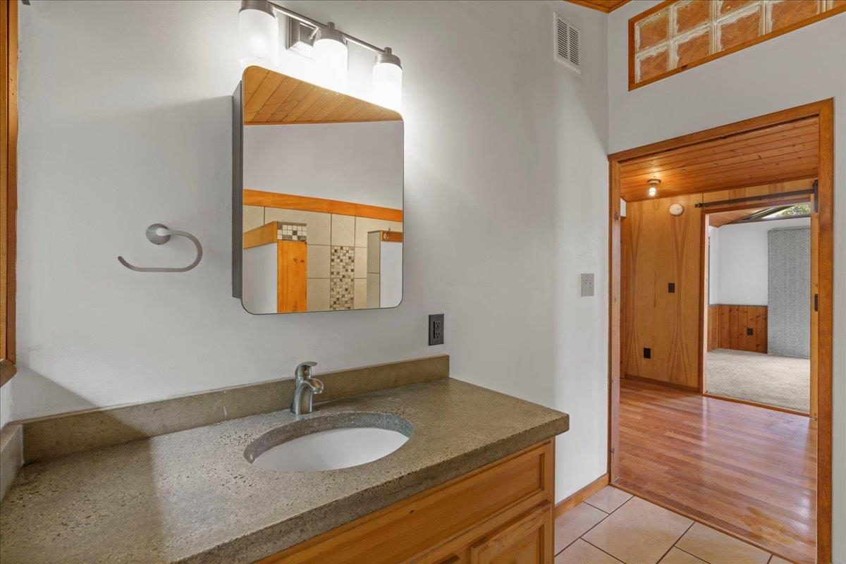 31 Hapapa Road, Unit B Kula, HI 96790 - Photo 30 of 50 a bathroom with a granite countertop sink and a mirror