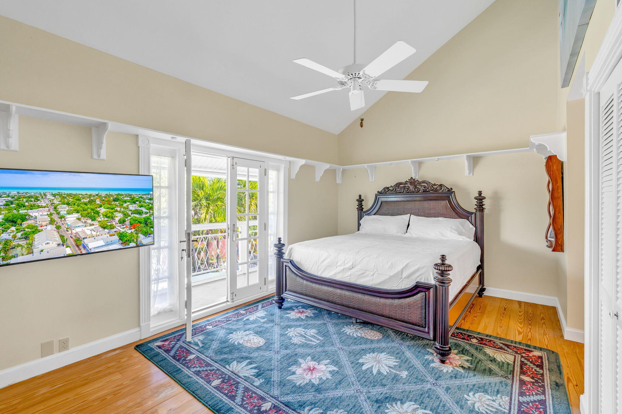 3365 Flagler Avenue Key West, FL 33040 - Photo 15 of 37 a bedroom with a bed and a chandelier