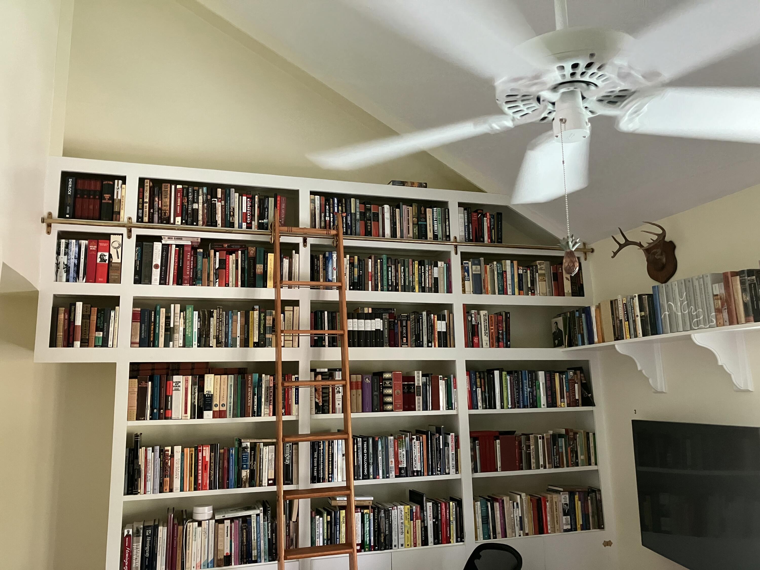 3365 Flagler Avenue Key West, FL 33040 - Photo 32 of 37 a living room with lots of books and a book shelf