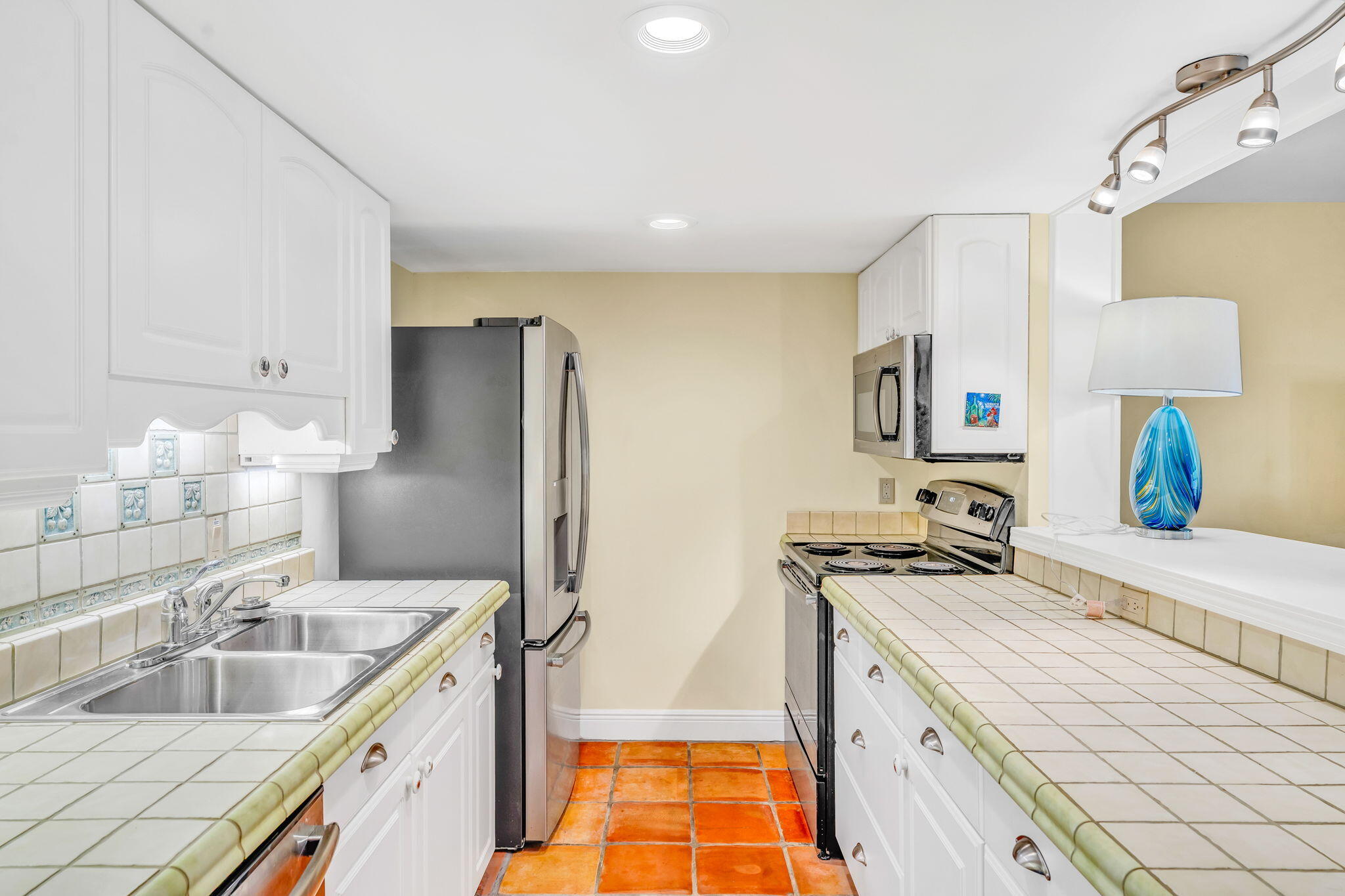 3365 Flagler Avenue Key West, FL 33040 - Photo 7 of 37 a kitchen that has a sink a stove and a refrigerator