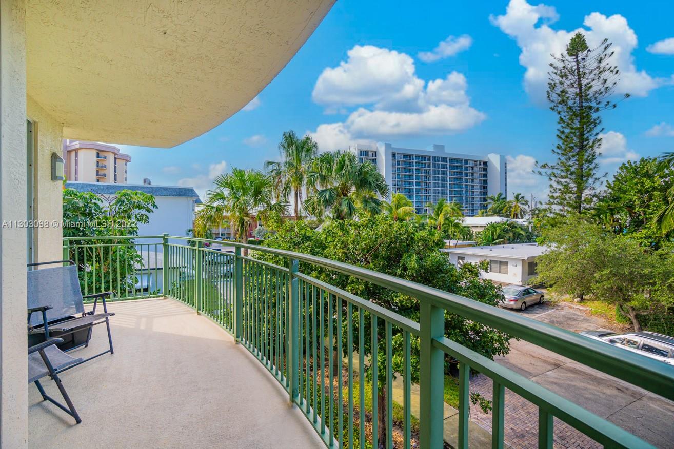 3210 Northeast 5th Street, Unit 203 Pompano Beach, FL 33062 - Photo 20 of 34 a house view with a garden space