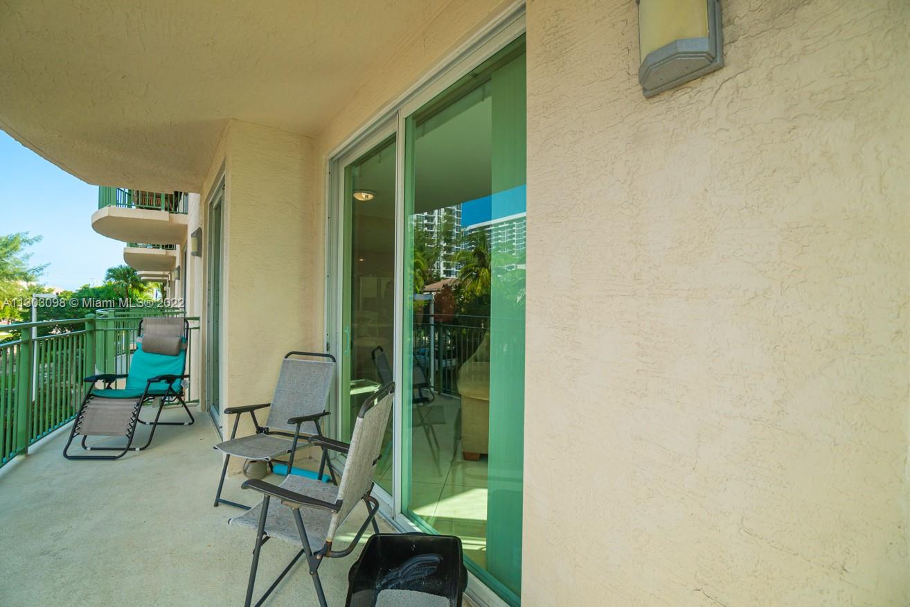 3210 Northeast 5th Street, Unit 203 Pompano Beach, FL 33062 - Photo 23 of 34 a balcony with chairs and a potted plant