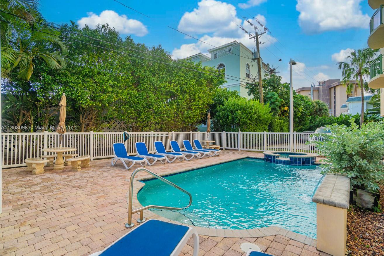 3210 Northeast 5th Street, Unit 203 Pompano Beach, FL 33062 - Photo 24 of 34 a view of a house with backyard and sitting area