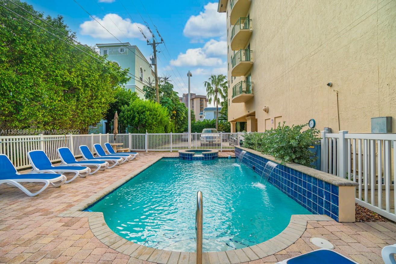 3210 Northeast 5th Street, Unit 203 Pompano Beach, FL 33062 - Photo 25 of 34 a view of a swimming pool with a sitting space