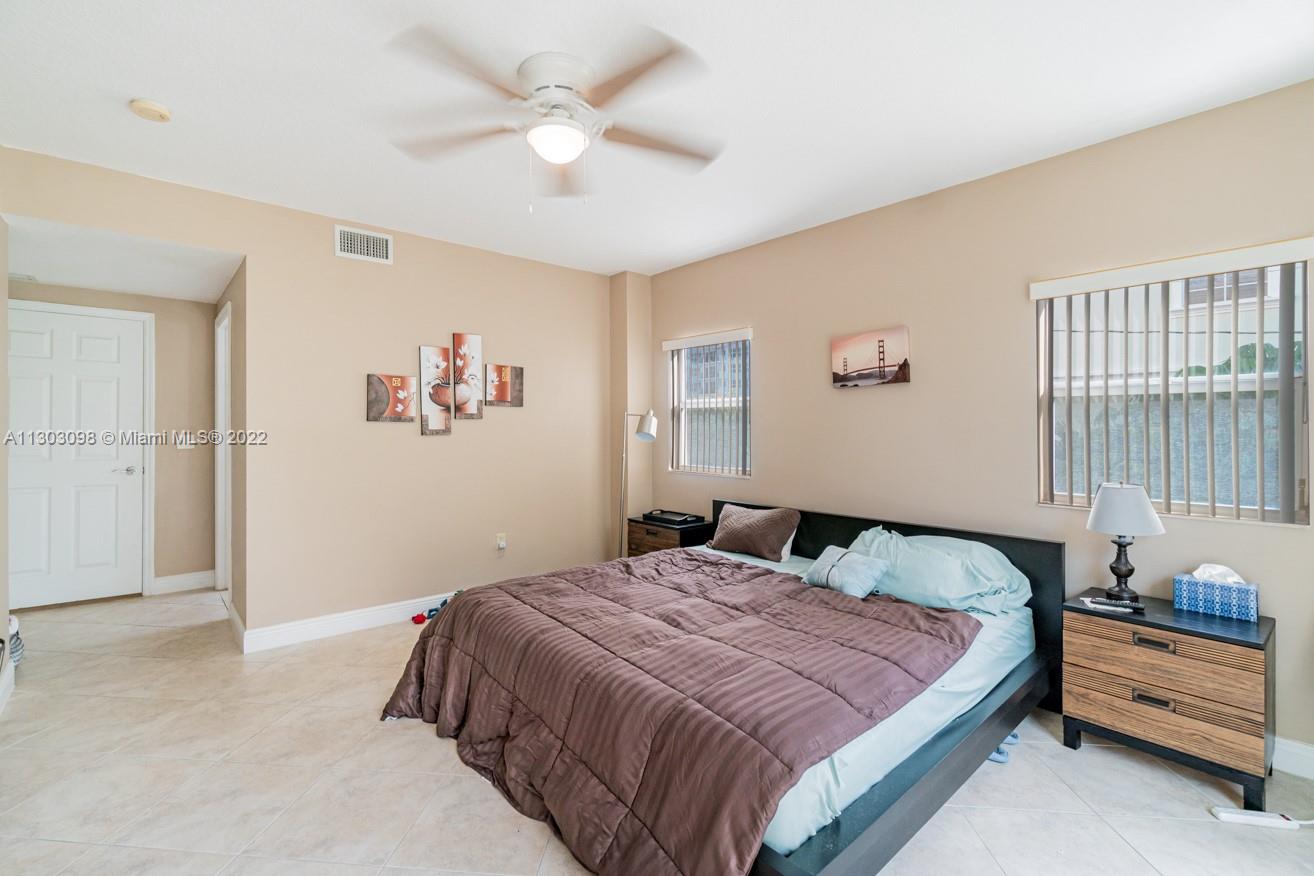 3210 Northeast 5th Street, Unit 203 Pompano Beach, FL 33062 - Photo 31 of 34 a bedroom with a bed and a window