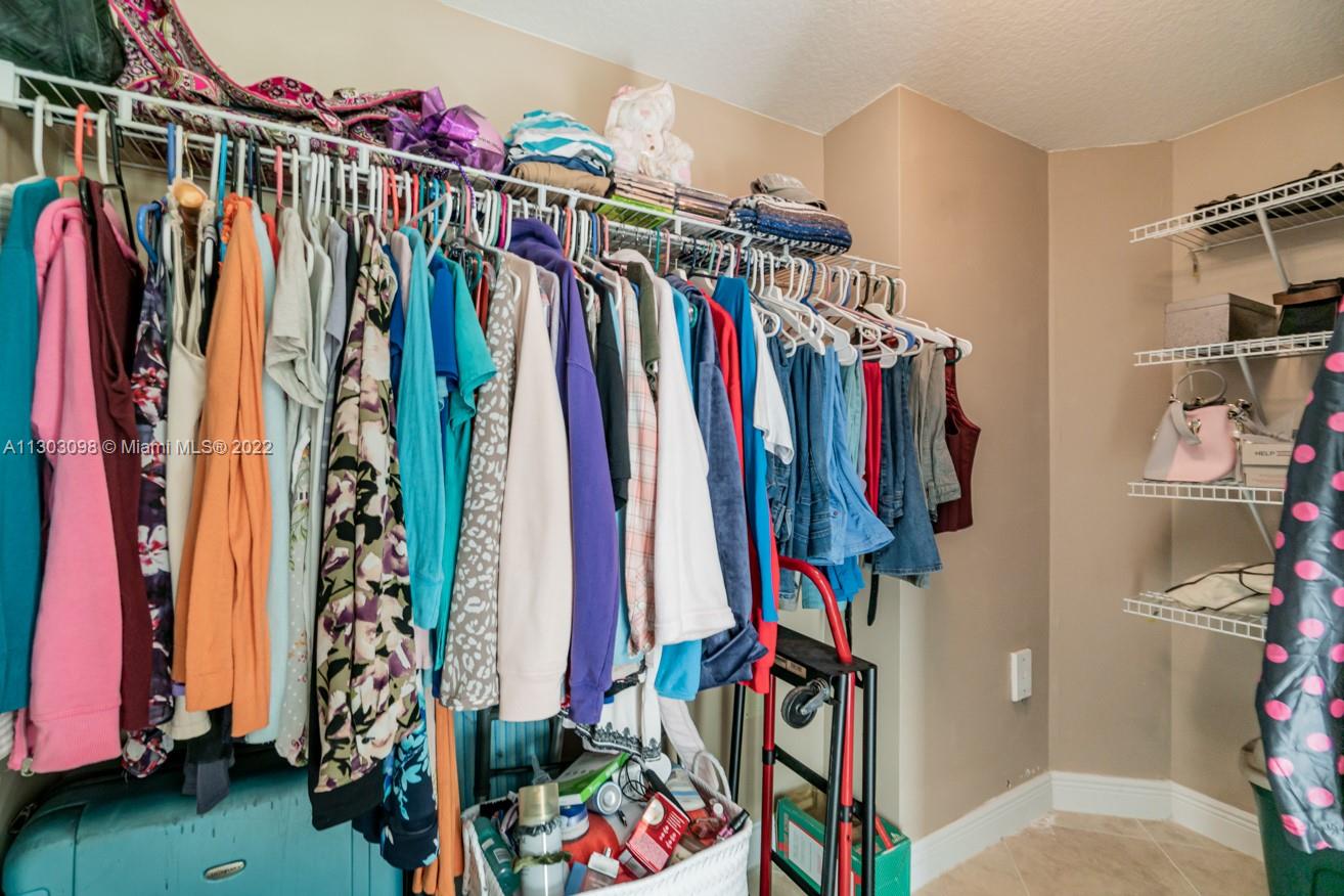 3210 Northeast 5th Street, Unit 203 Pompano Beach, FL 33062 - Photo 32 of 34 a view of walk in closet with clothes