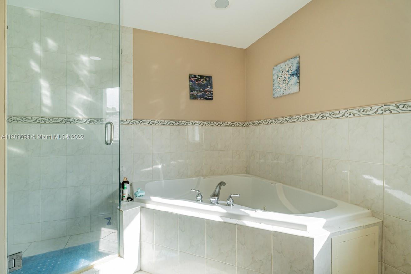 3210 Northeast 5th Street, Unit 203 Pompano Beach, FL 33062 - Photo 34 of 34 a bathroom with a tub and a shower