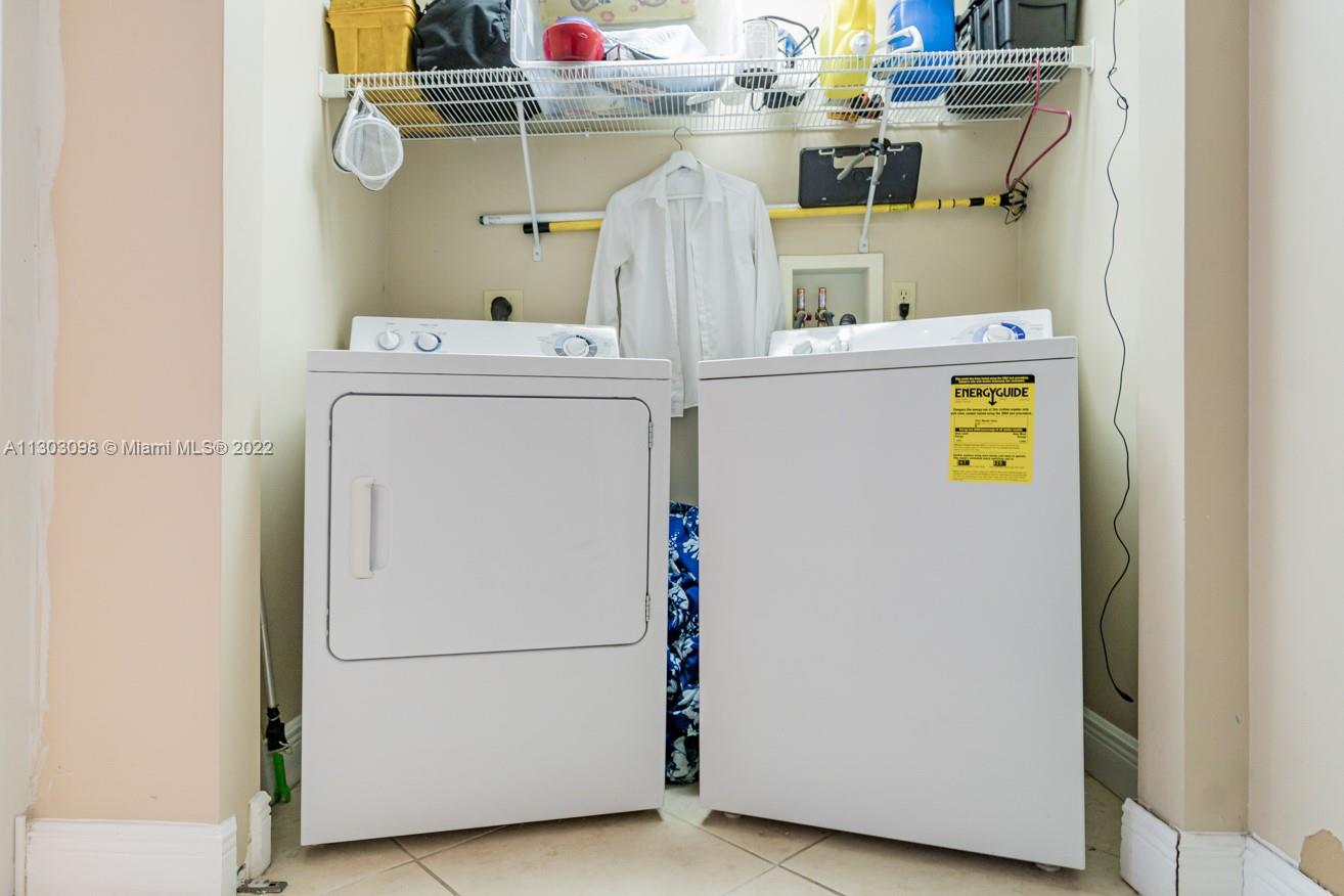 3210 Northeast 5th Street, Unit 203 Pompano Beach, FL 33062 - Photo 10 of 34 a utility room with dryer and washer