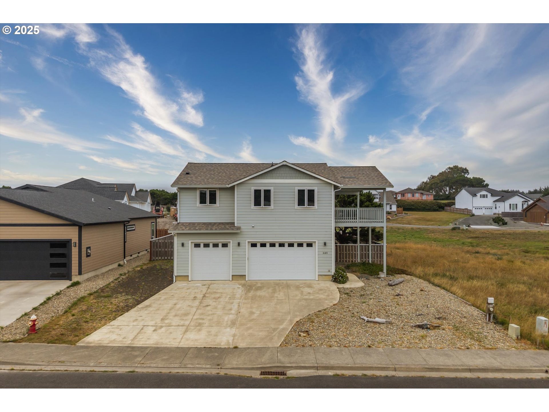 3145 Periwinkle Lane Southwest Bandon, OR 97411 - Photo 1 of 26 a view of a house with backyard and a kitchen