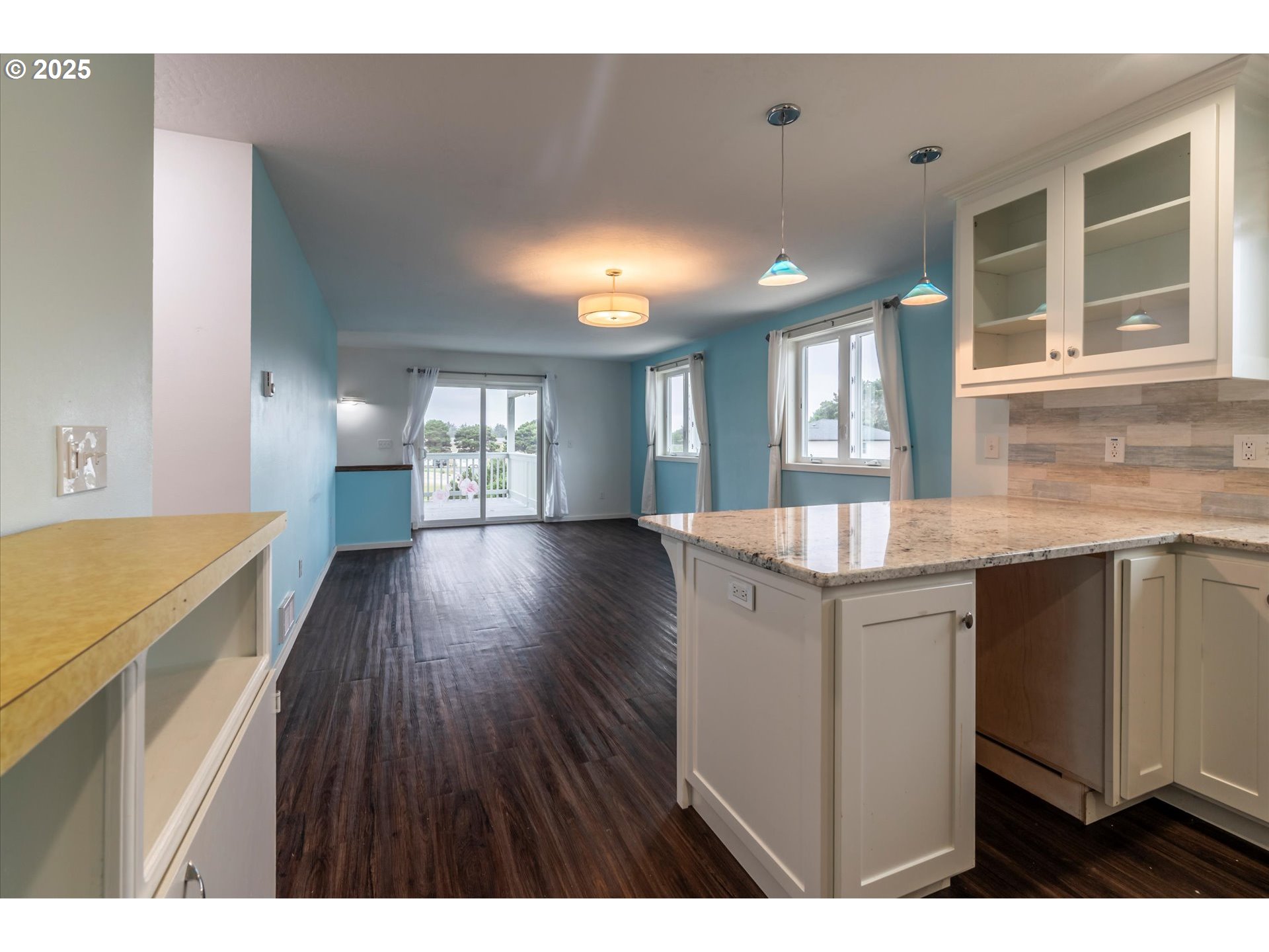 3145 Periwinkle Lane Southwest Bandon, OR 97411 - Photo 15 of 26 a open kitchen with a sink and dishwasher with wooden floor