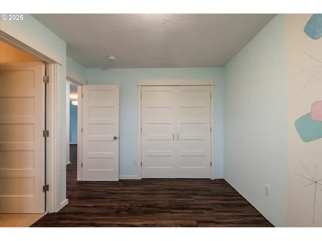 a view of an empty room and wooden floor