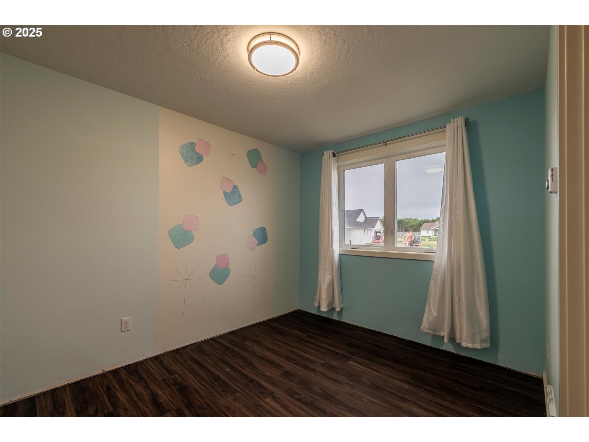 3145 Periwinkle Lane Southwest Bandon, OR 97411 - Photo 20 of 26 a view of an empty room and wooden floor