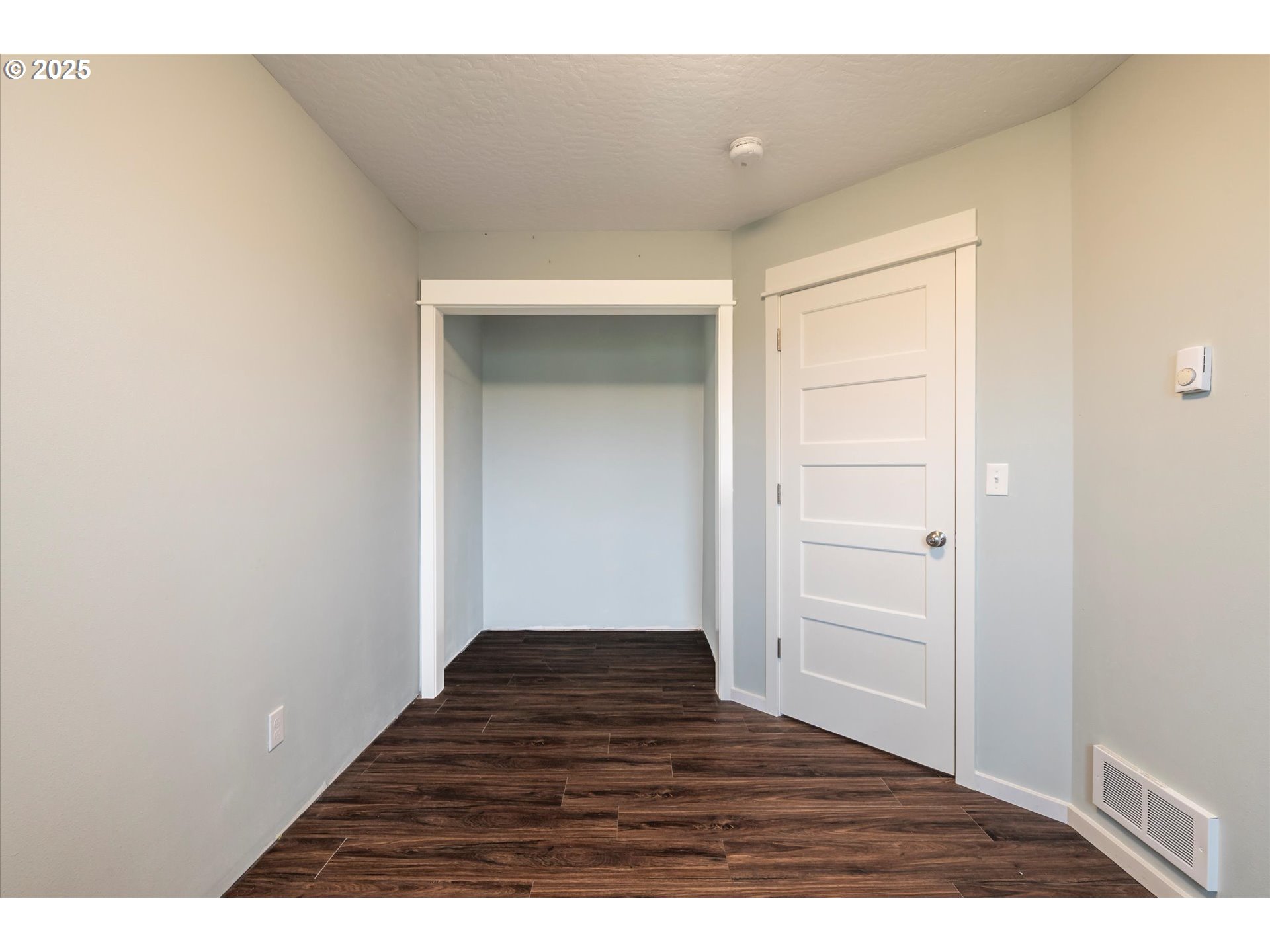 3145 Periwinkle Lane Southwest Bandon, OR 97411 - Photo 24 of 26 a view of an empty room and wooden floor