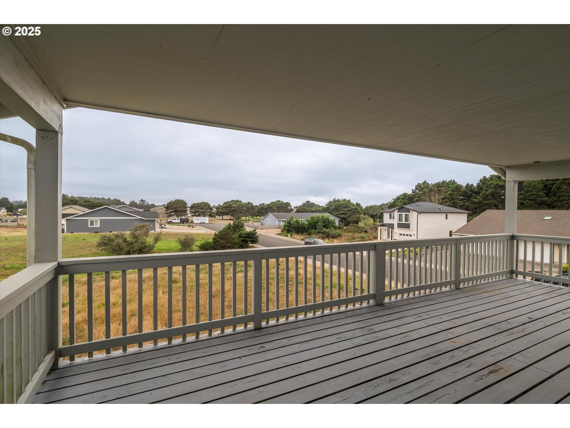 3145 Periwinkle Lane Southwest Bandon, OR 97411 - Photo 26 of 26 a view of balcony with wooden floor